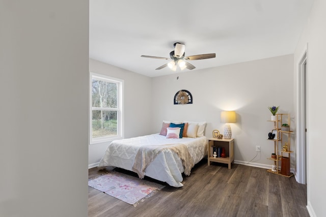 bedroom with dark wood-type flooring, baseboards, and a ceiling fan