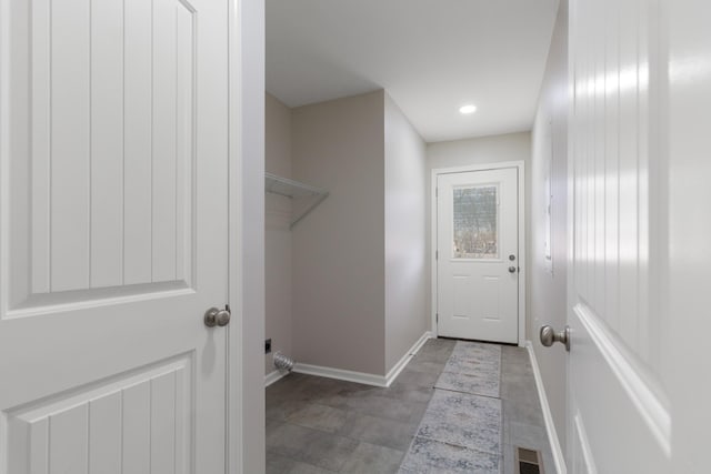 clothes washing area featuring visible vents and baseboards