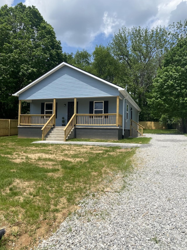 119 Noles St, Decherd, TN 37324 - bungalow featuring fence, a porch, gravel driveway, and a front yard