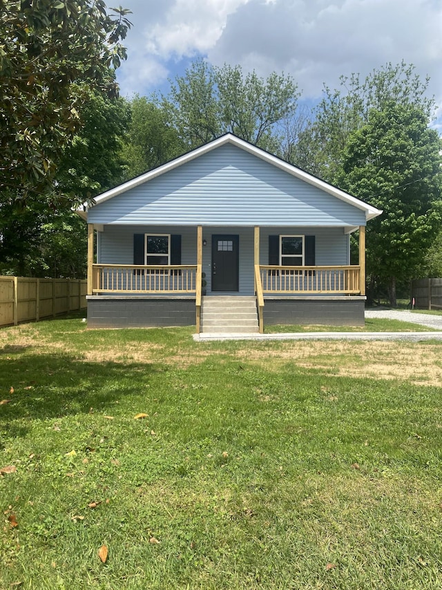 119 Noles St, Decherd, TN 37324 - bungalow with a porch, fence, and a front yard
