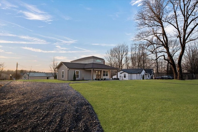 back of property featuring a lawn