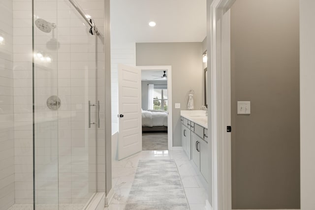 bathroom featuring ceiling fan, vanity, and a shower with shower door