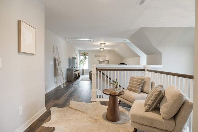 living area with lofted ceiling and dark hardwood / wood-style flooring