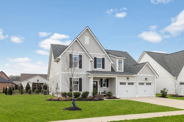 modern inspired farmhouse featuring a garage, a front yard, and central air condition unit