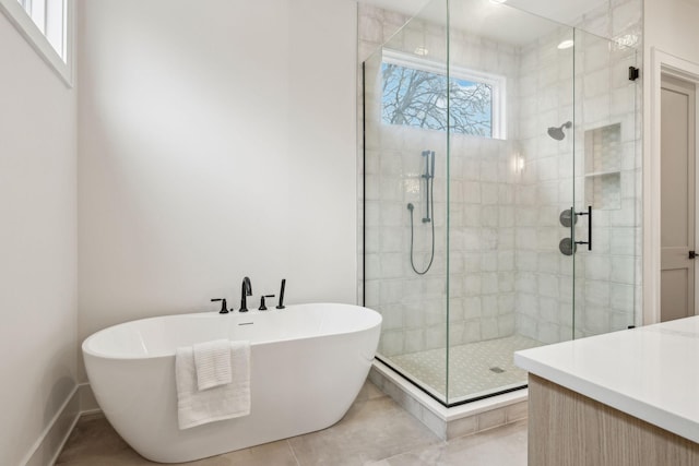 bathroom with tile patterned floors and shower with separate bathtub