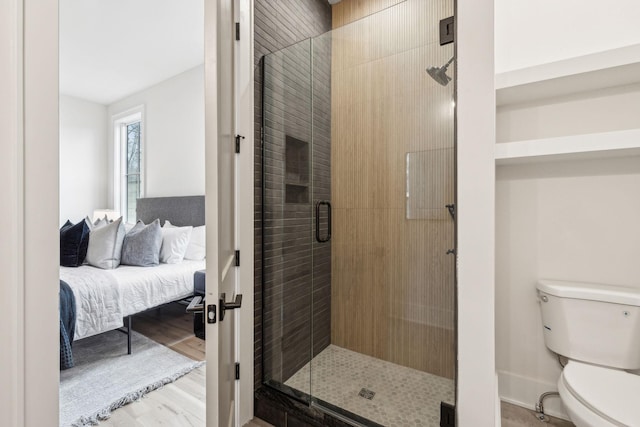 bathroom featuring an enclosed shower, hardwood / wood-style floors, and toilet