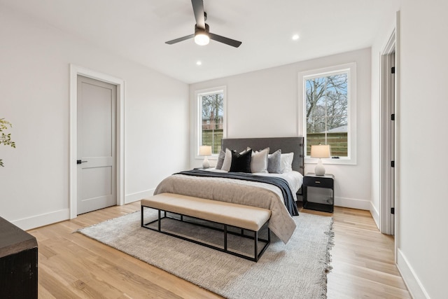 bedroom with ceiling fan and light hardwood / wood-style flooring