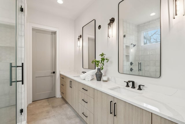 bathroom featuring vanity and a shower with shower door