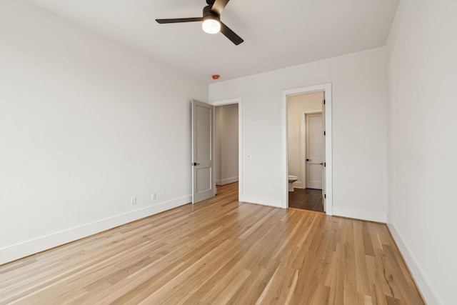 unfurnished bedroom with ceiling fan, ensuite bath, and light hardwood / wood-style floors