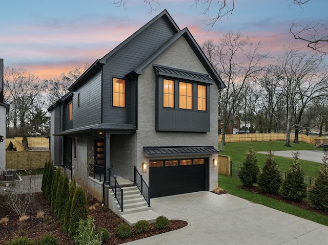 view of front of property featuring a garage and a yard