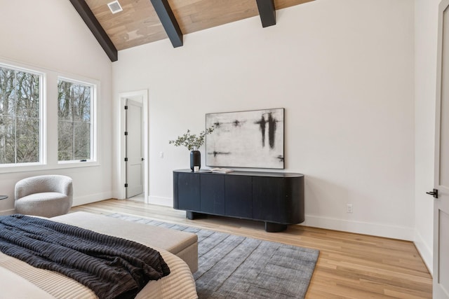 bedroom featuring beamed ceiling, high vaulted ceiling, wood ceiling, and light hardwood / wood-style floors