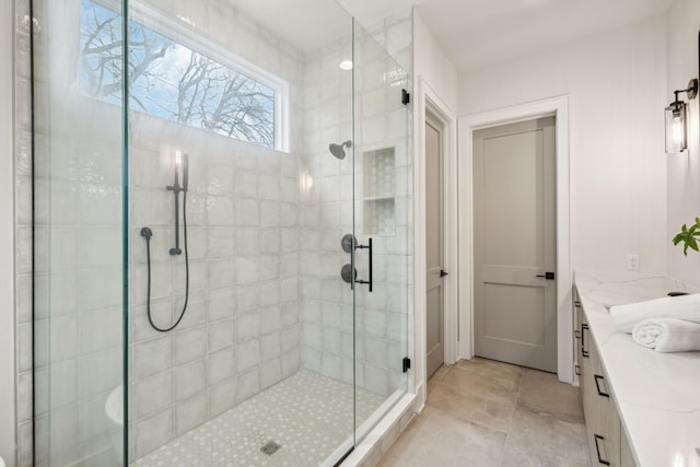 bathroom with tile patterned floors, vanity, and an enclosed shower