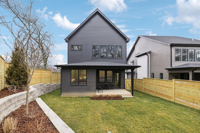 rear view of house featuring a lawn and a patio area