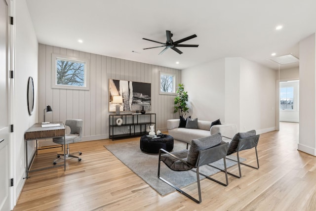 living room with ceiling fan and light hardwood / wood-style flooring