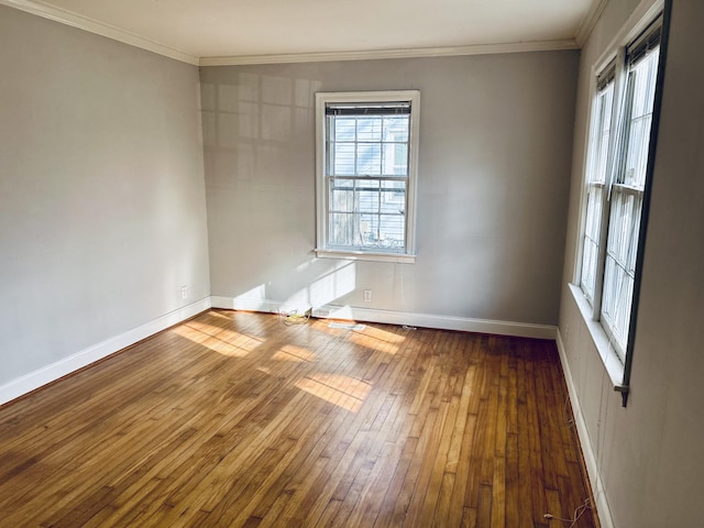 unfurnished room with ornamental molding, dark wood finished floors, and baseboards