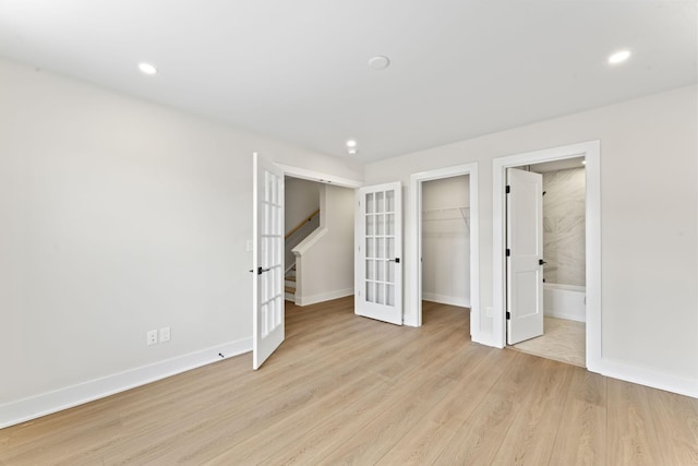 unfurnished bedroom featuring recessed lighting, french doors, light wood-type flooring, and baseboards