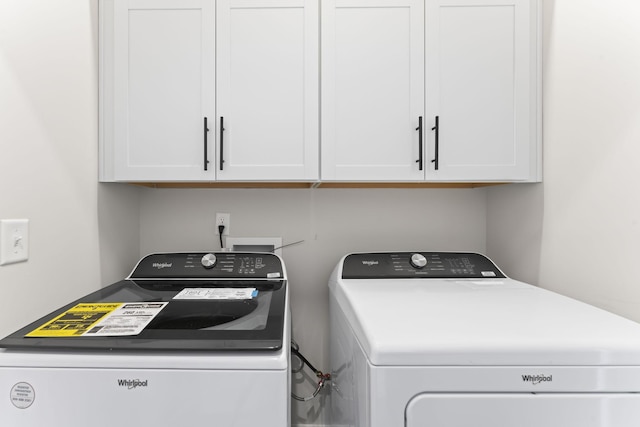 laundry area with cabinet space and washer and clothes dryer