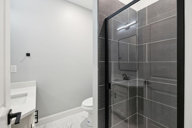 bathroom with vanity, an enclosed shower, and toilet