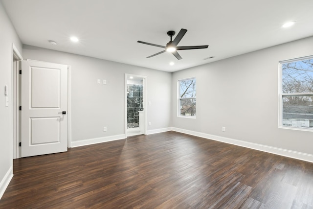 spare room featuring dark wood-type flooring and ceiling fan