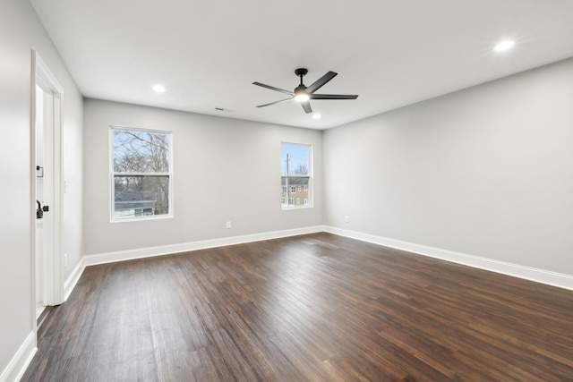 spare room with ceiling fan and dark hardwood / wood-style floors