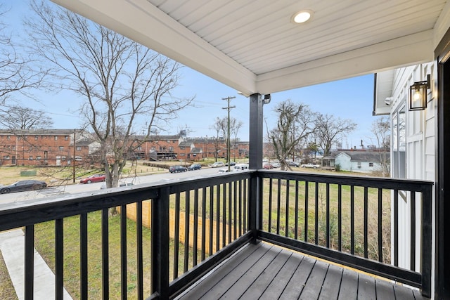 wooden terrace with a lawn