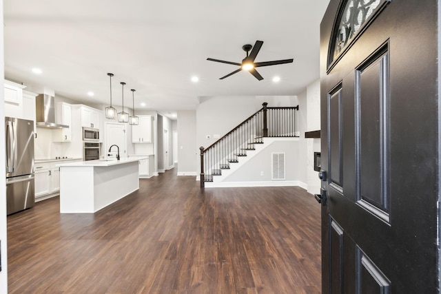 entryway with ceiling fan, sink, and dark hardwood / wood-style flooring