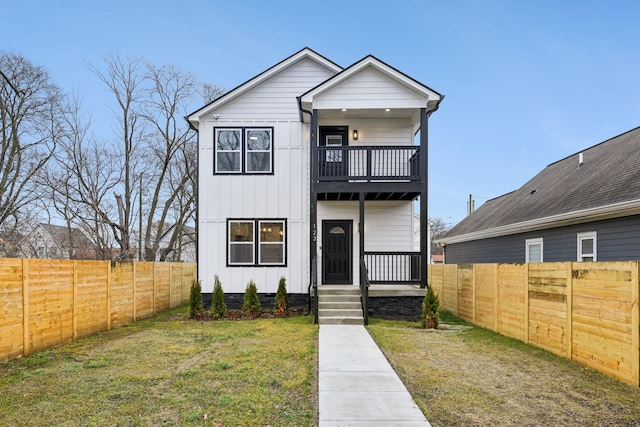 view of front of property with a balcony and a front yard