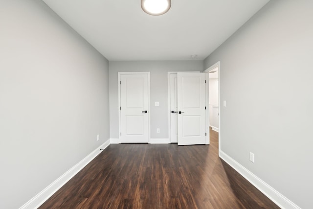 unfurnished bedroom featuring dark hardwood / wood-style flooring