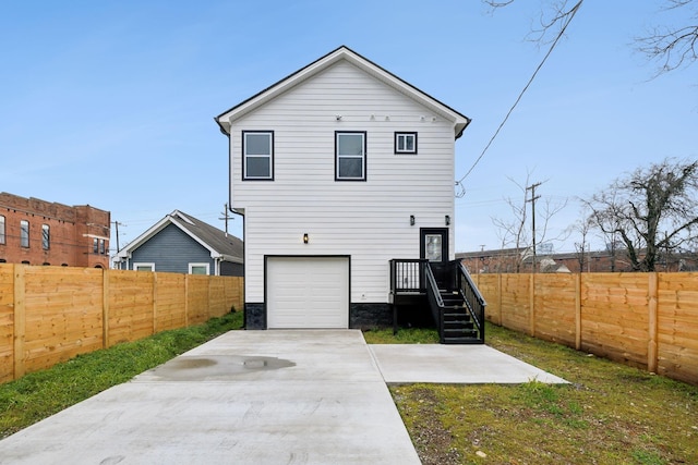 back of house with a garage