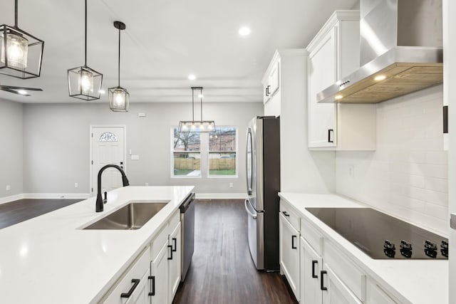 kitchen featuring white cabinetry, appliances with stainless steel finishes, sink, and wall chimney range hood