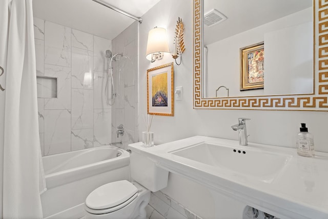 full bathroom featuring sink, toilet, and shower / bath combo