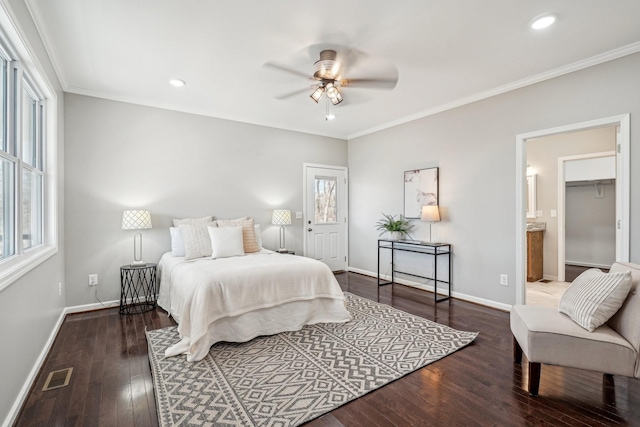 bedroom featuring ornamental molding, dark hardwood / wood-style floors, connected bathroom, and ceiling fan