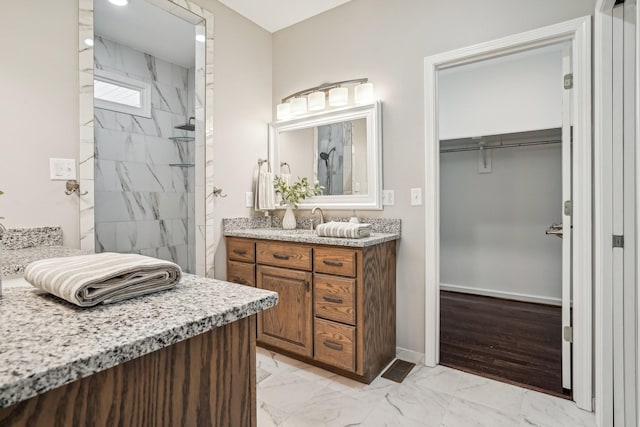 bathroom featuring vanity and a tile shower