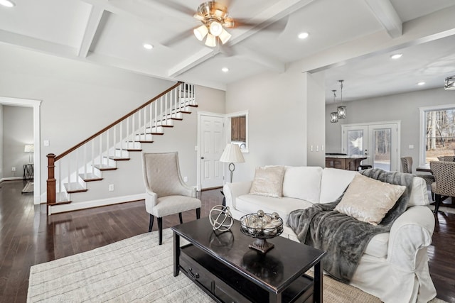 living room with beamed ceiling, wood-type flooring, coffered ceiling, and ceiling fan