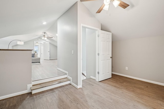 additional living space featuring vaulted ceiling, light hardwood / wood-style floors, and ceiling fan