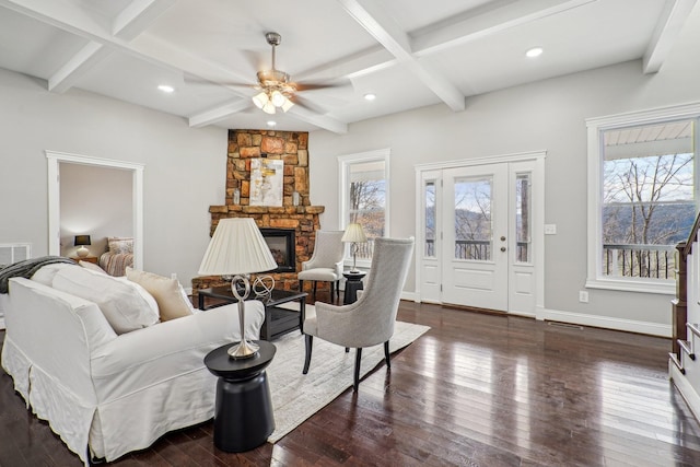 living room with beam ceiling, coffered ceiling, dark hardwood / wood-style floors, and a fireplace