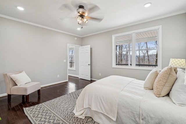 bedroom with crown molding, dark hardwood / wood-style floors, and ceiling fan