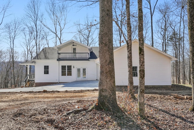 back of property featuring french doors and a balcony