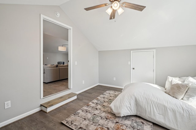 bedroom with vaulted ceiling, dark wood-type flooring, and ceiling fan