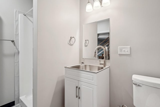 bathroom with vanity, toilet, and walk in shower