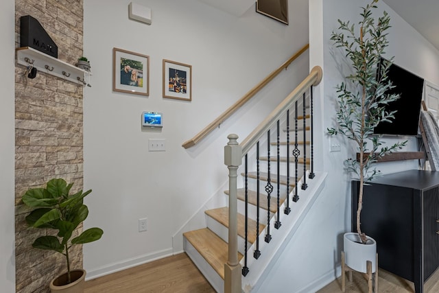 stairs featuring wood-type flooring