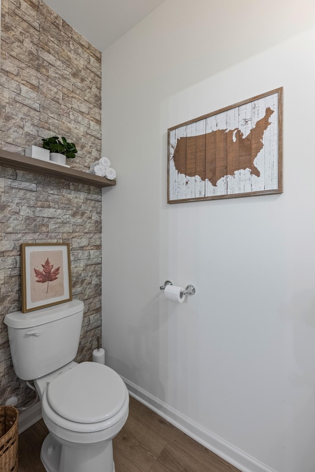 bathroom featuring hardwood / wood-style flooring and toilet