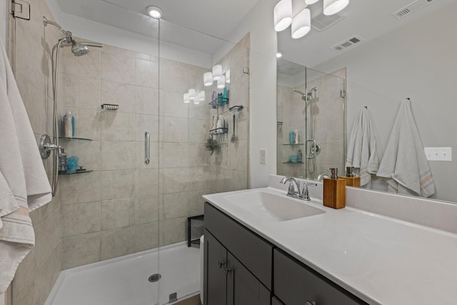 bathroom with vanity and a shower with shower door