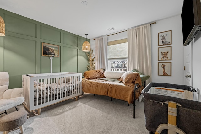 bedroom featuring light colored carpet