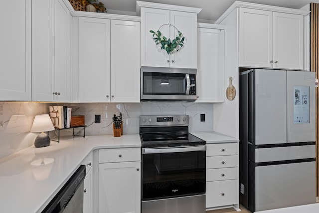 kitchen with white cabinetry, decorative backsplash, and appliances with stainless steel finishes