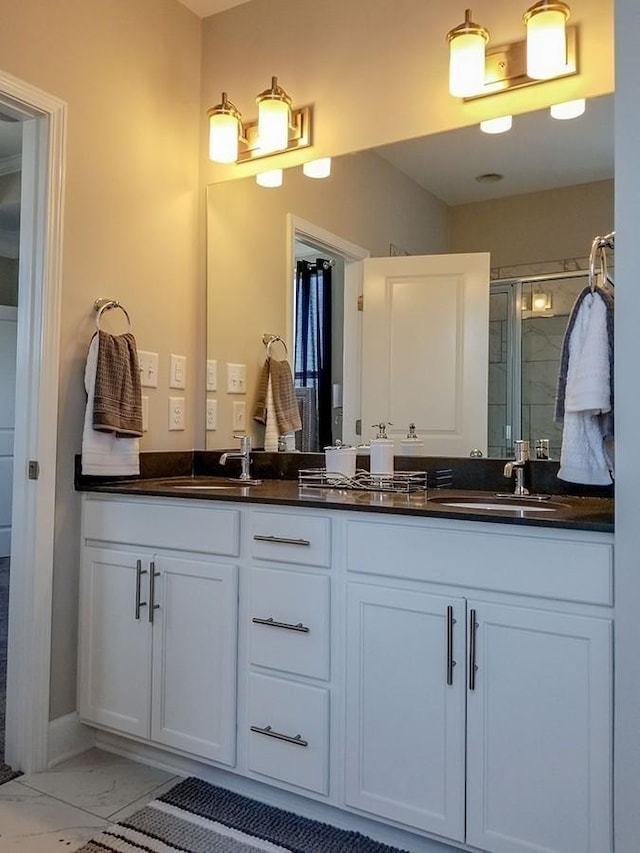 bathroom featuring walk in shower and vanity