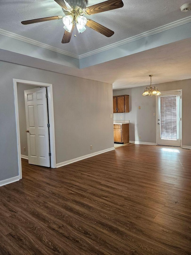 unfurnished living room with ceiling fan with notable chandelier, dark wood-type flooring, ornamental molding, and a textured ceiling