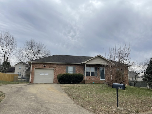 ranch-style home with a garage and a front yard