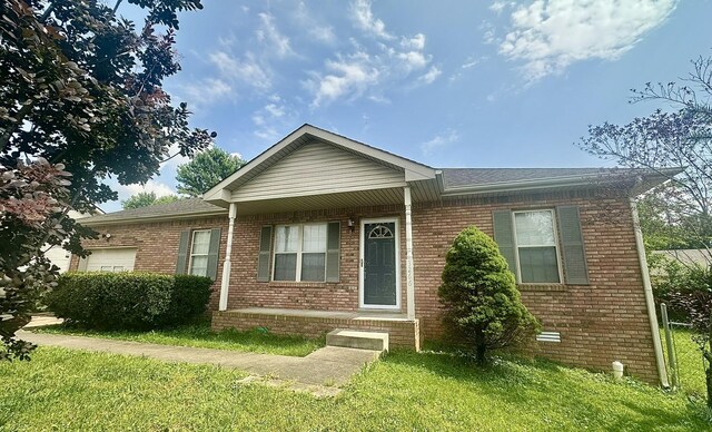 3266 Tabby Dr, Clarksville, TN 37042 - ranch-style home with brick siding, an attached garage, and a front lawn