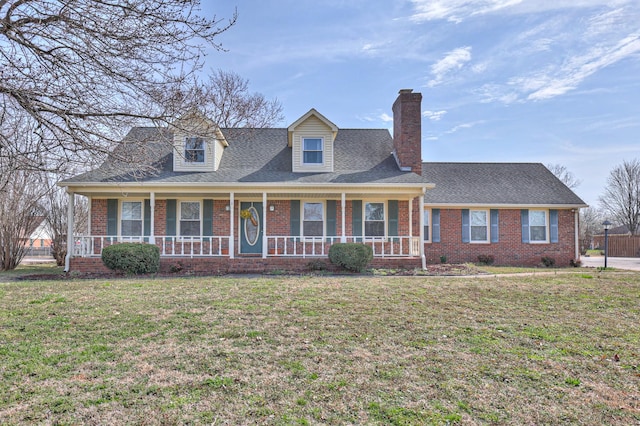 cape cod house with brick siding, a shingled roof, a front lawn, a porch, and a chimney